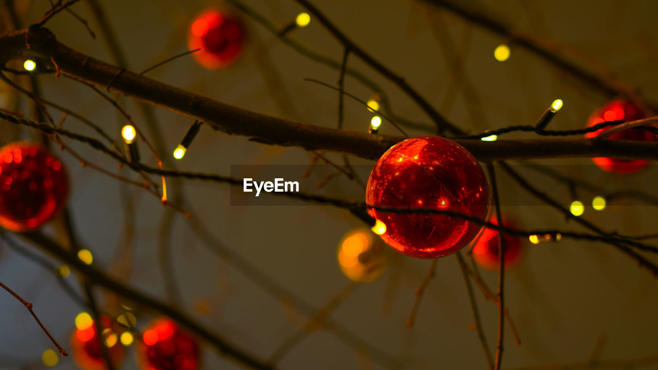 LOW ANGLE VIEW OF CHRISTMAS LIGHTS HANGING FROM CEILING