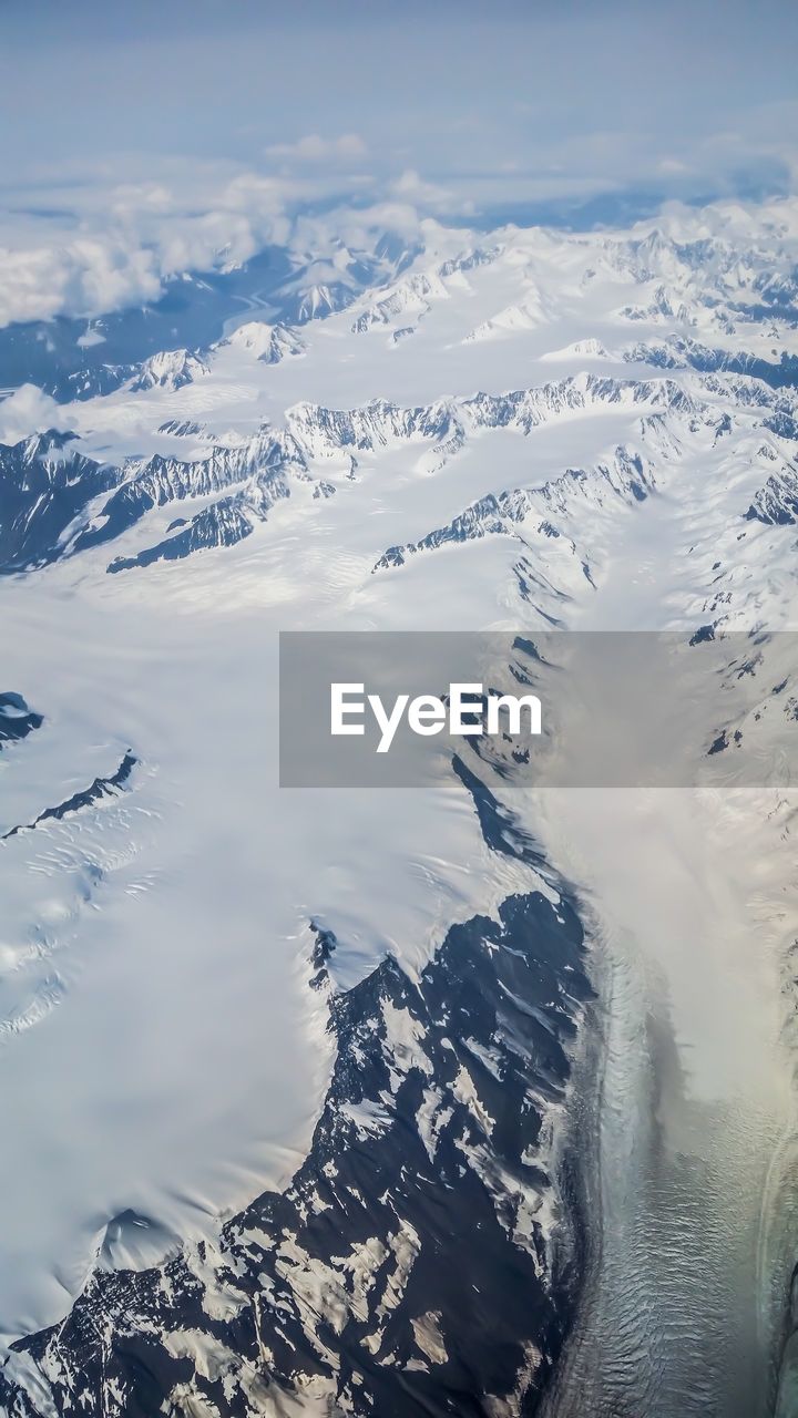 Aerial view of snowcapped mountains against sky