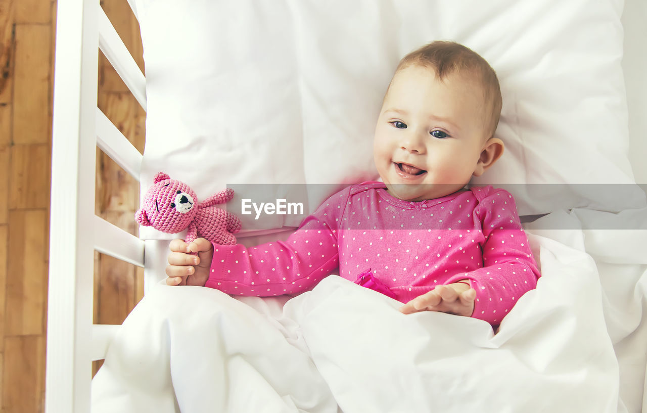 portrait of cute baby boy sleeping on bed at home