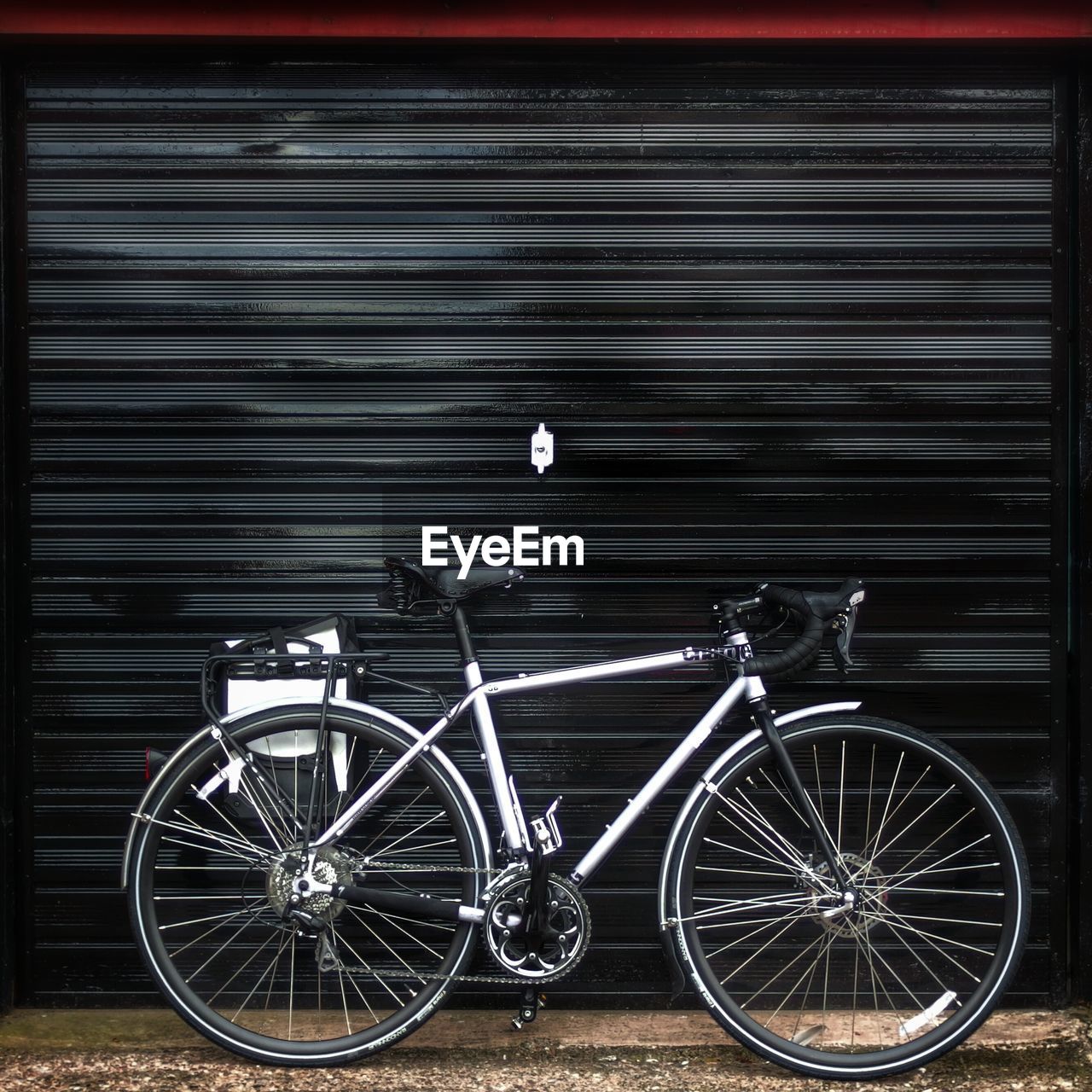 Bicycle leaning on shutter