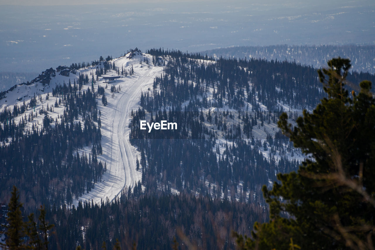 mountain, scenics - nature, beauty in nature, environment, tree, nature, water, plant, cold temperature, landscape, mountain range, wilderness, land, snow, winter, no people, sky, forest, pinaceae, pine tree, coniferous tree, travel destinations, tranquility, non-urban scene, outdoors, tranquil scene, ridge, travel, sea, day, pine woodland, tourism, reflection, high angle view