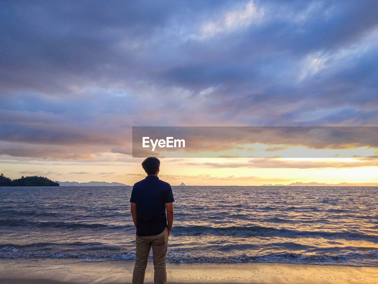 Rear view of man standing on beach