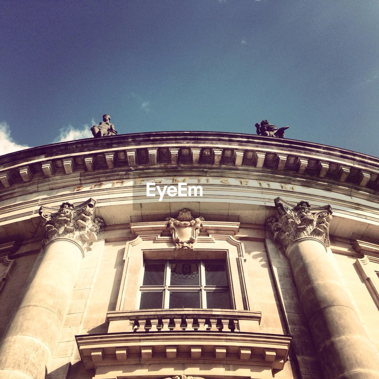 Low angle view of bode museum against blue sky