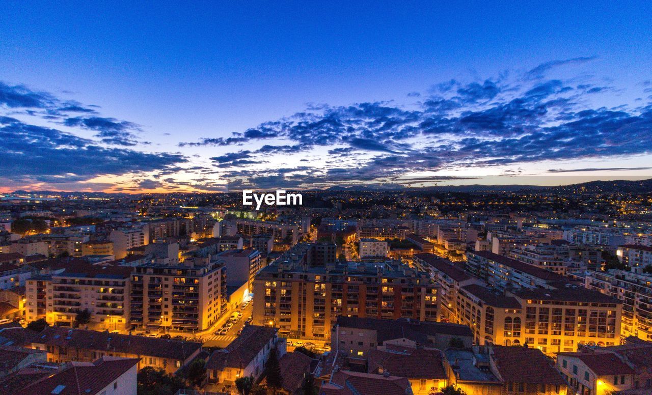 High angle view of illuminated cityscape against sky