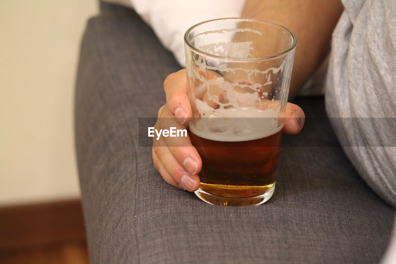 Midsection of woman drinking glass