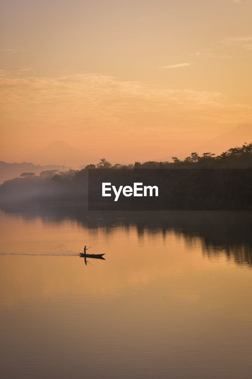 Scenic view of river against sky during sunrise