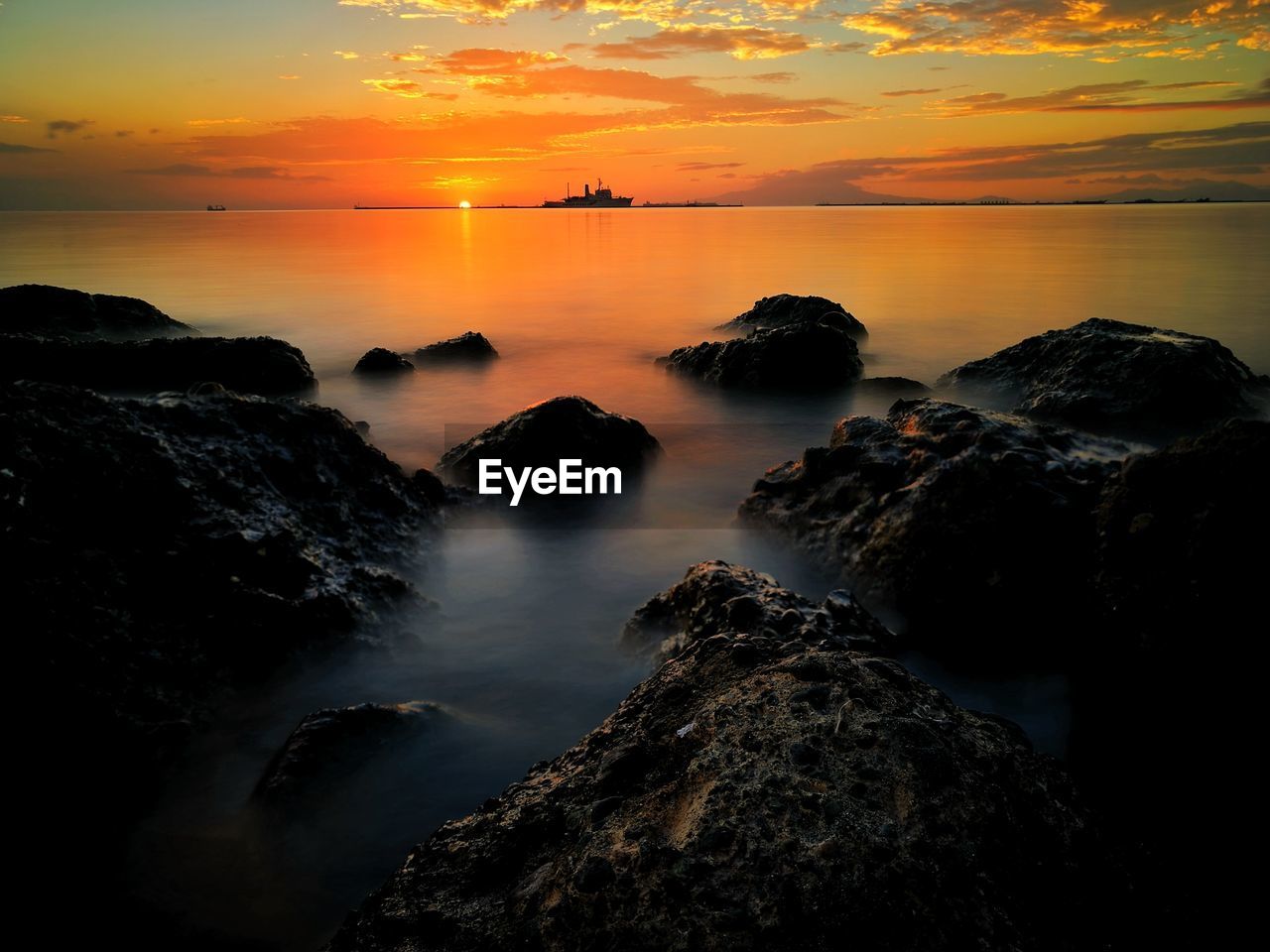 Scenic view of sea against sky during sunset