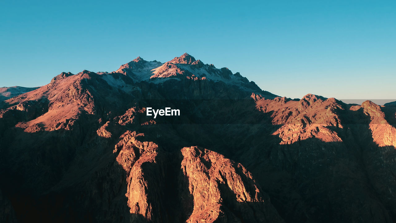 Scenic view of mountain range against clear sky