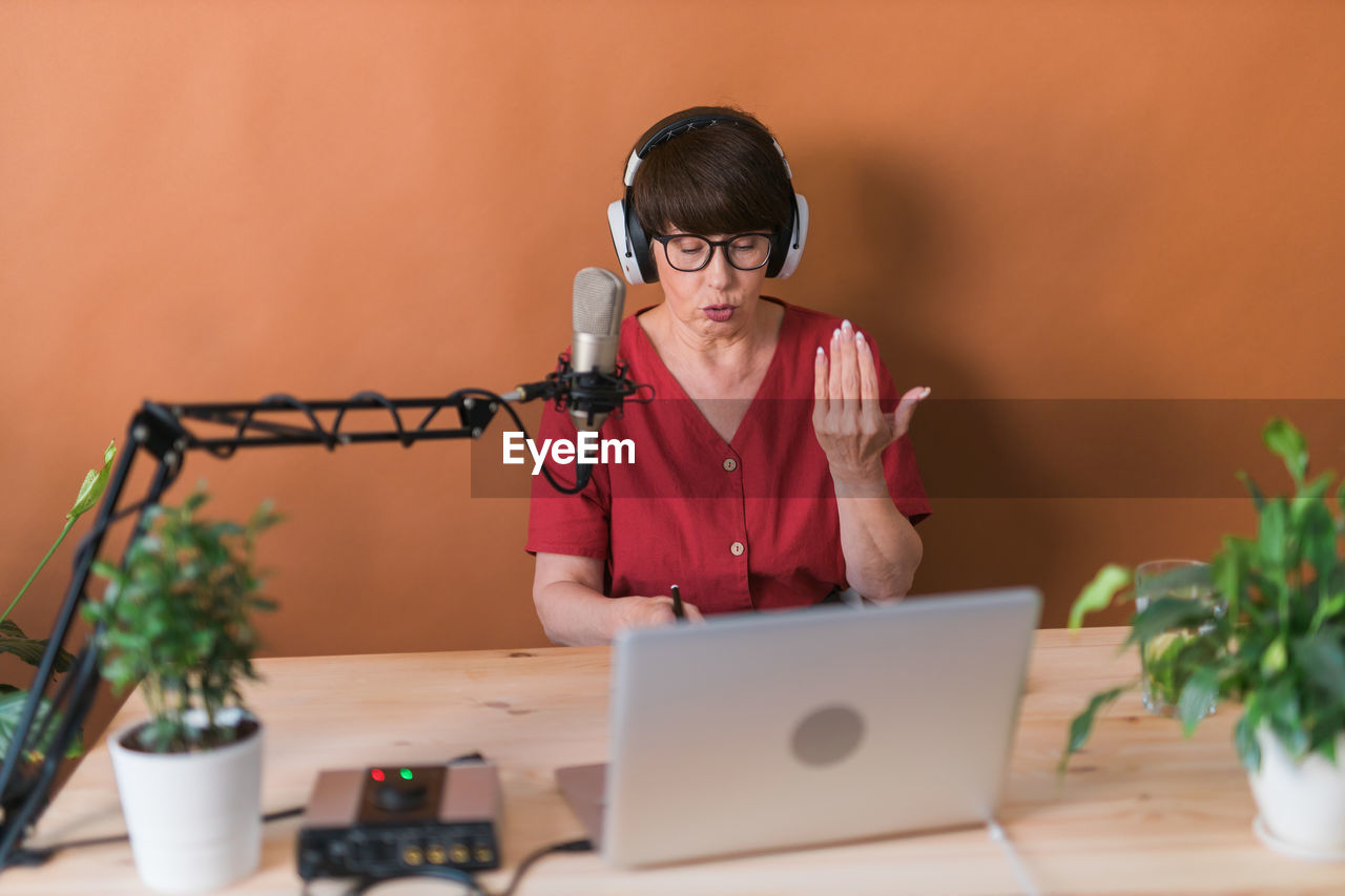 Side view of woman using laptop on table