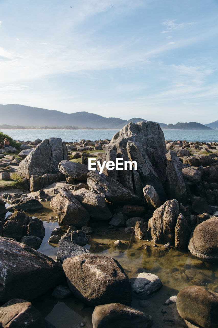 Rocks on beach against sky