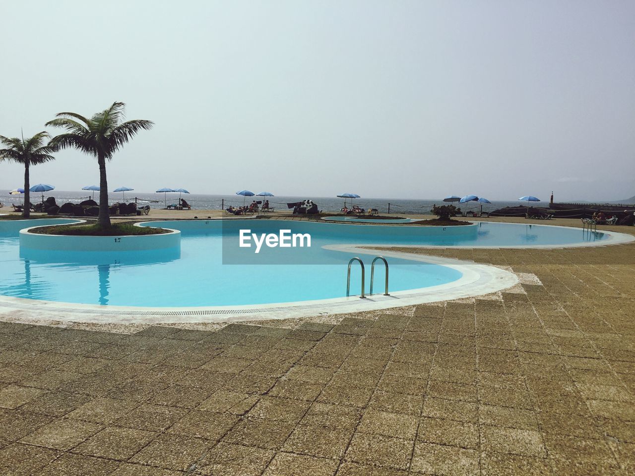 SWIMMING POOL BY SEA AGAINST CLEAR SKY