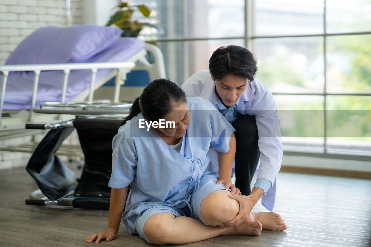 high angle view of mother and daughter sitting on floor