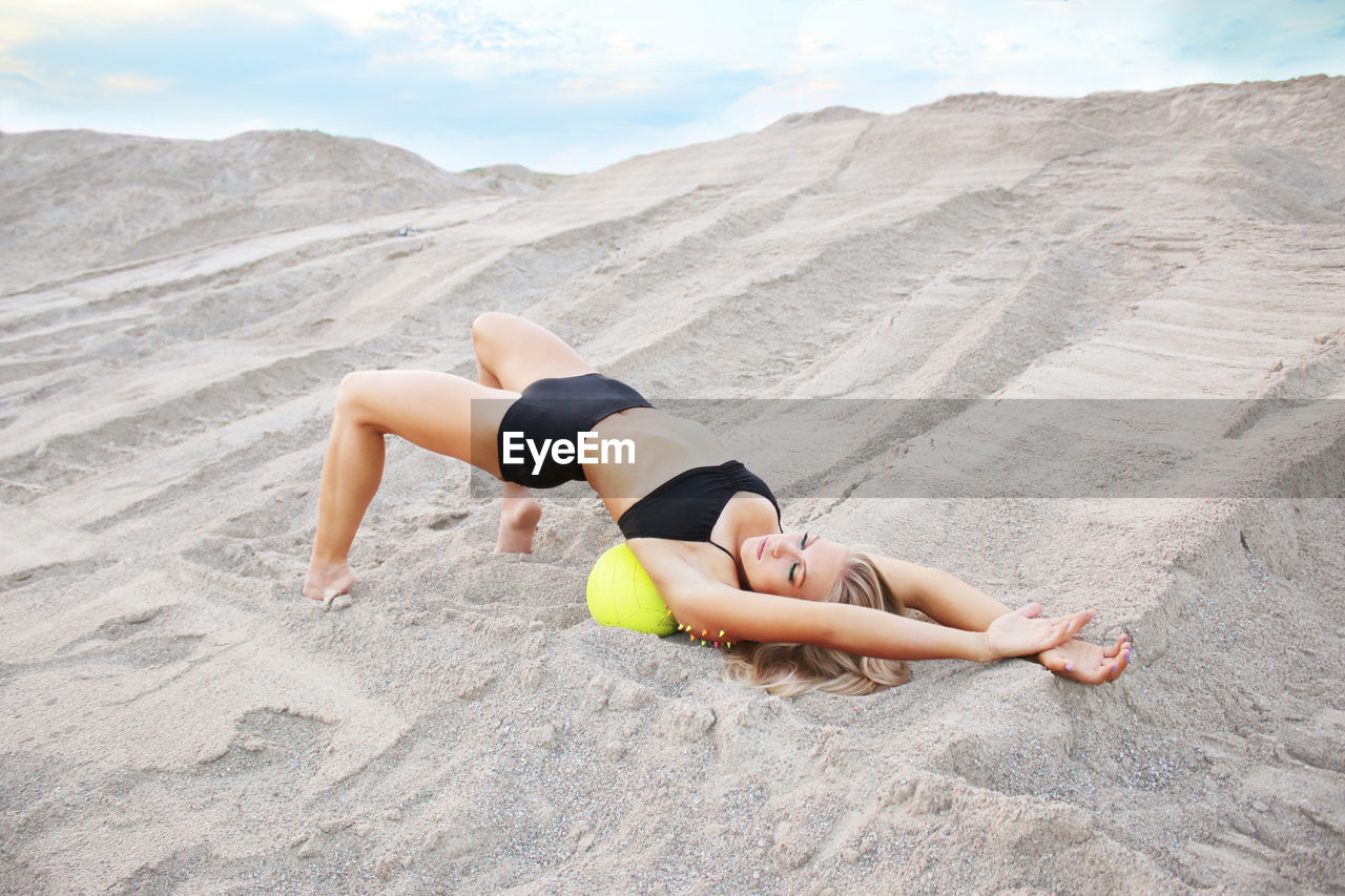 WOMAN RELAXING ON BEACH