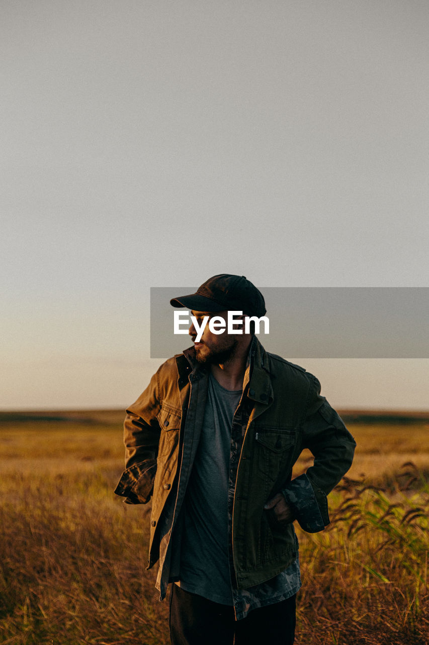 Portrait of a man in a field at sunset