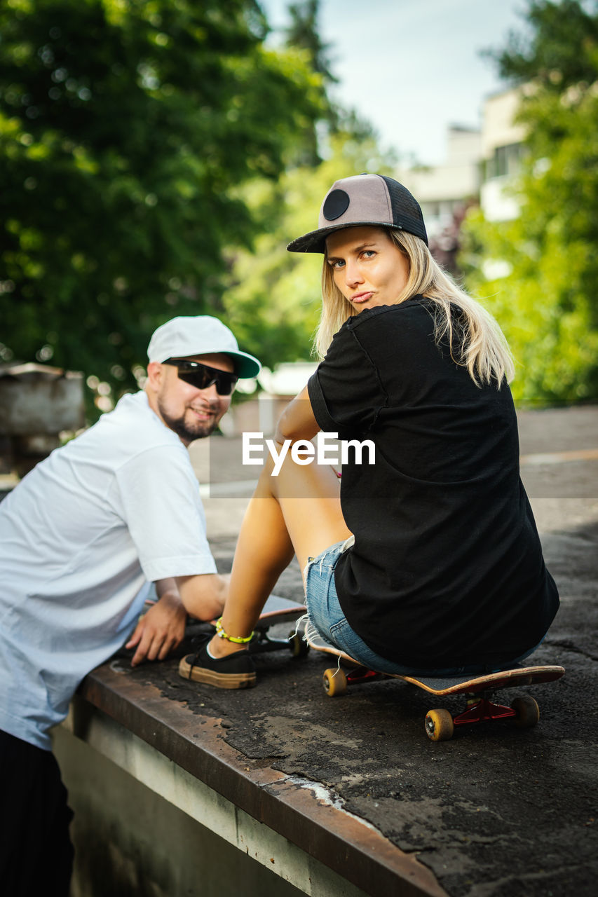 Portrait of smiling couple at skateboard park