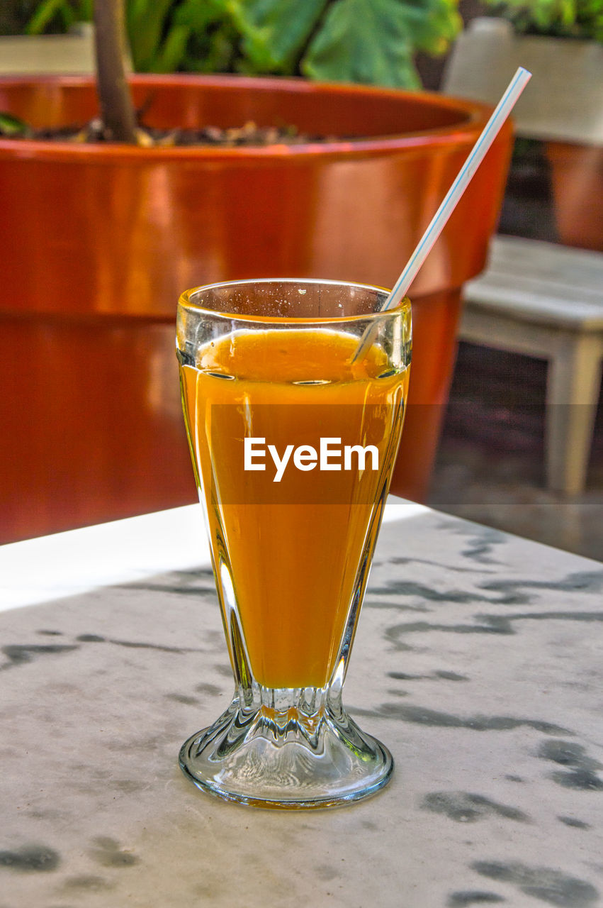 Close-up of glass of orange drink 