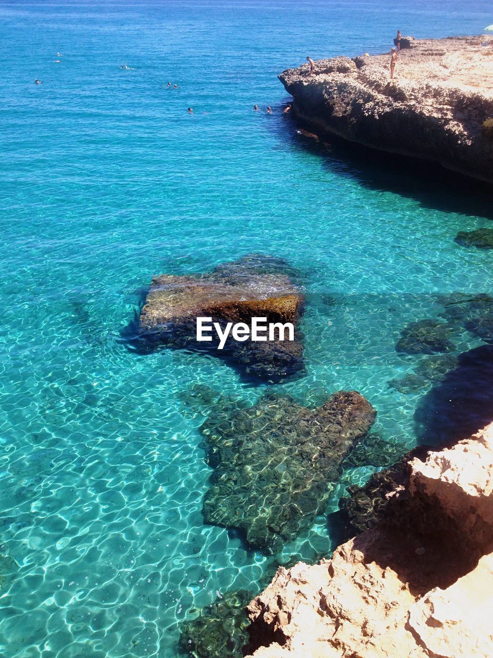 High angle view of rock formations by sea