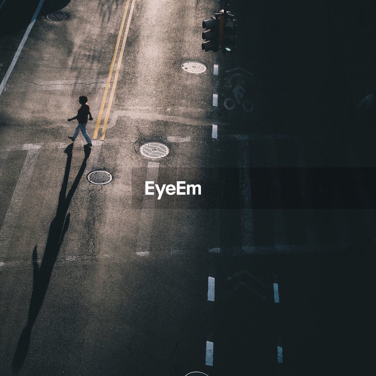 High angle view of woman crossing city street