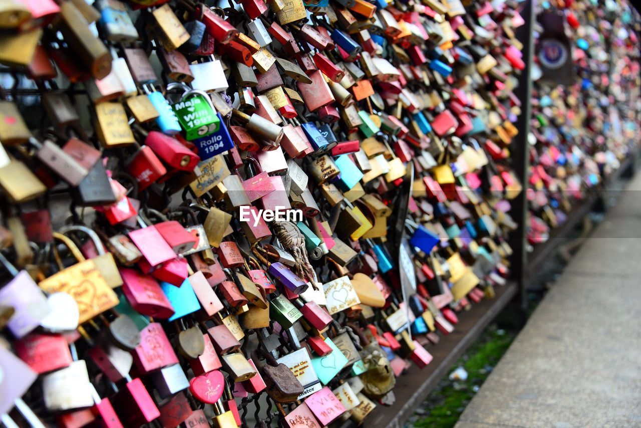 Close-up of padlocks hanging on railing