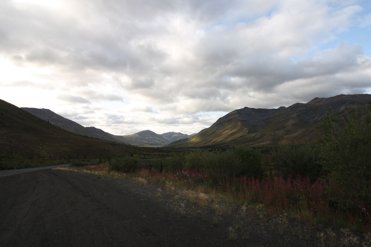 ROAD AMIDST MOUNTAINS AGAINST SKY