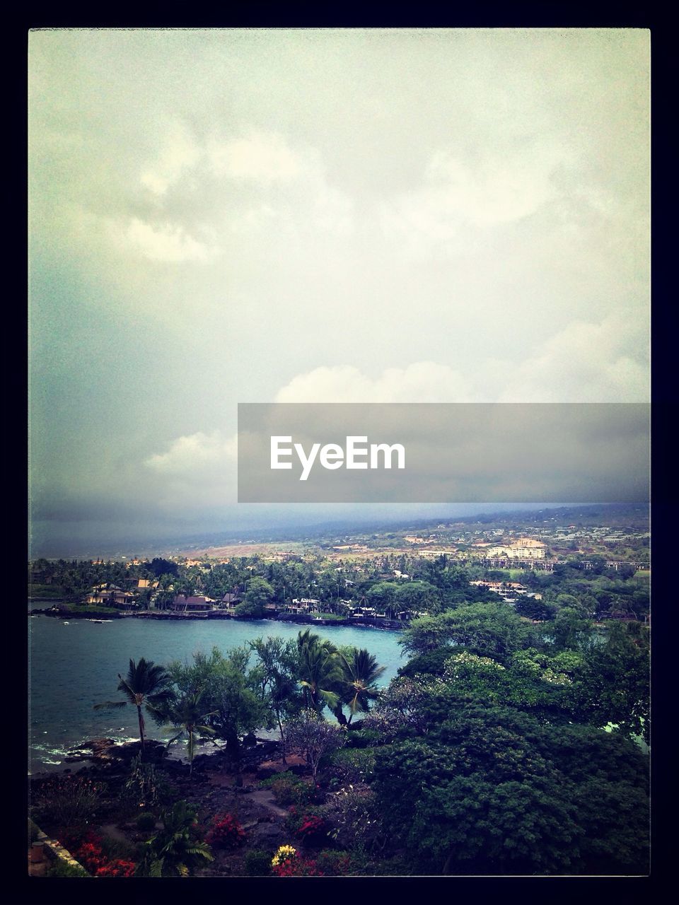 VIEW OF CITYSCAPE AGAINST CLOUDY SKY