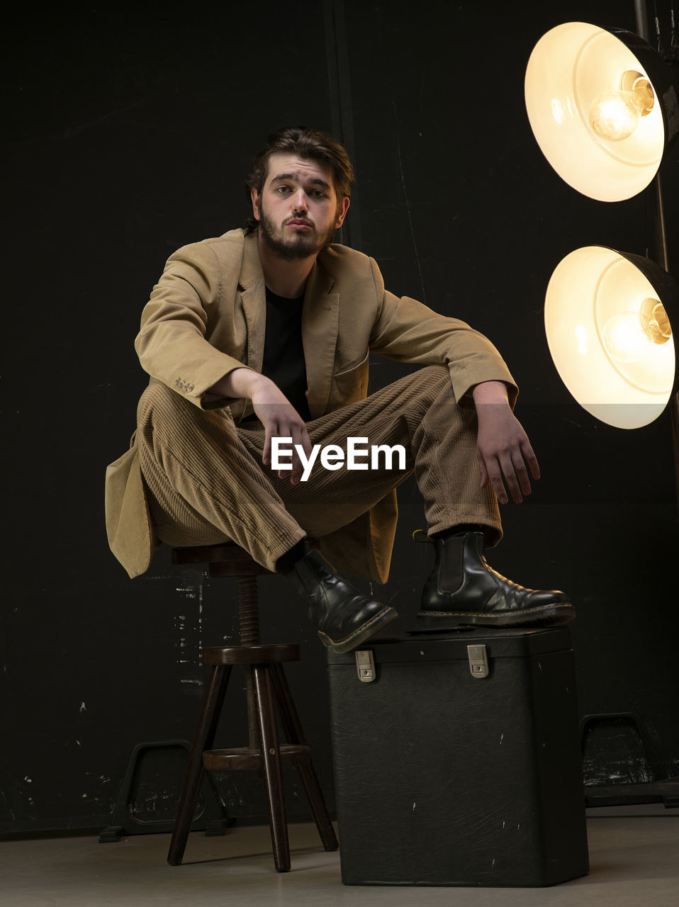 Male model sitting on chair looking foward