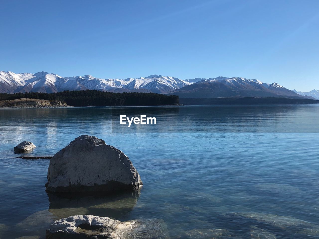 Scenic view of lake and snowcapped mountains against sky