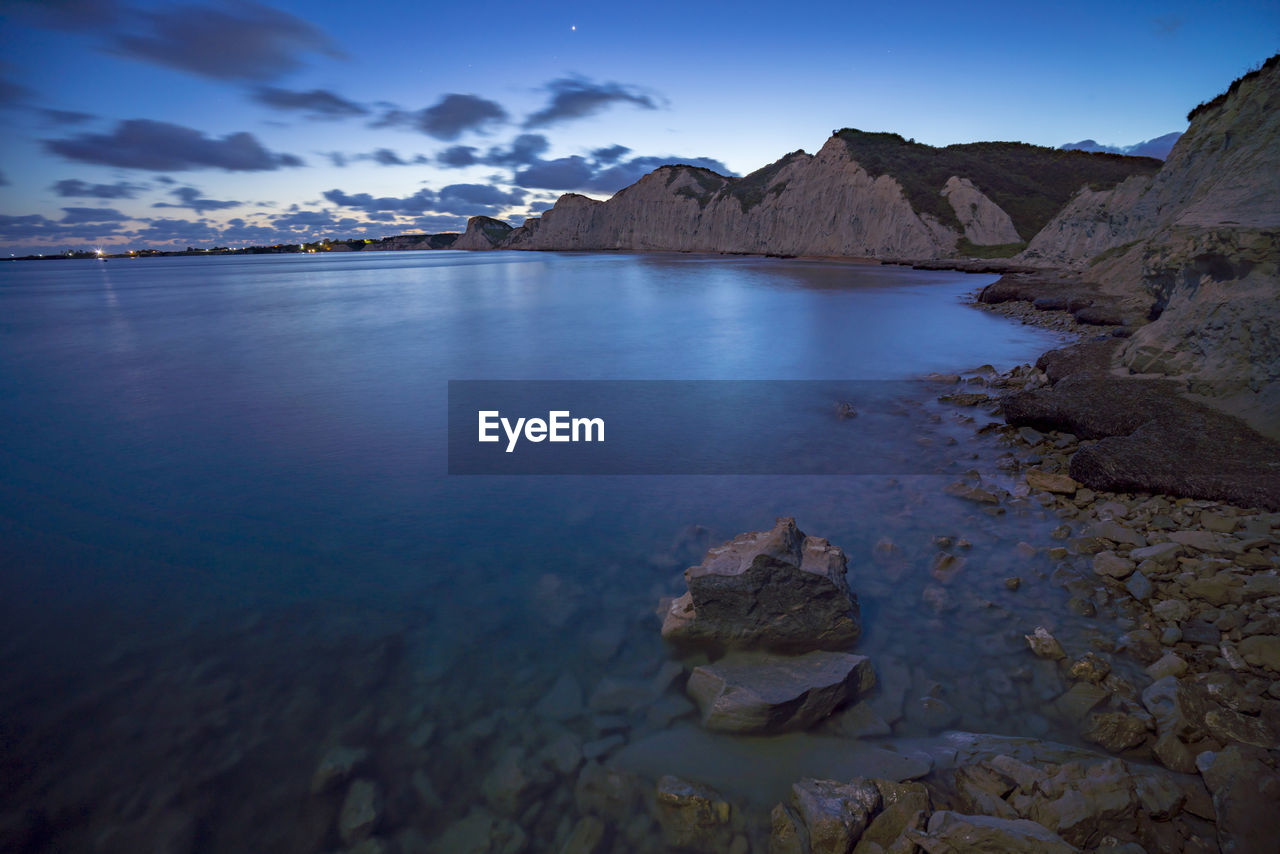 Scenic view of sea and rocks against sky