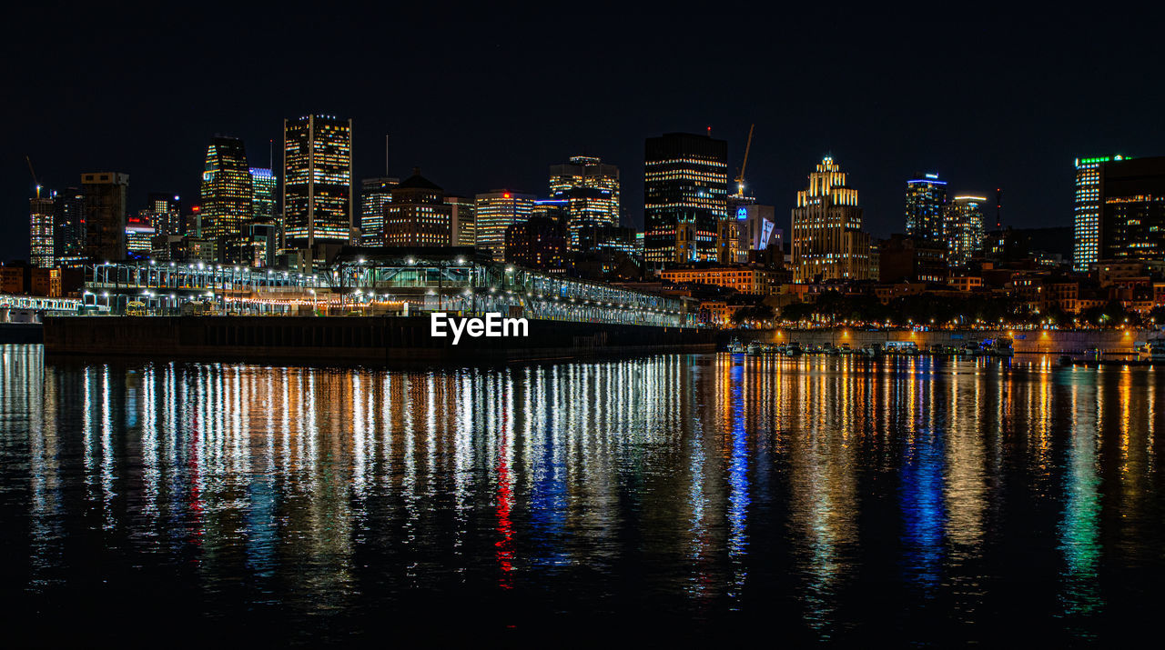 Illuminated modern buildings in city at night