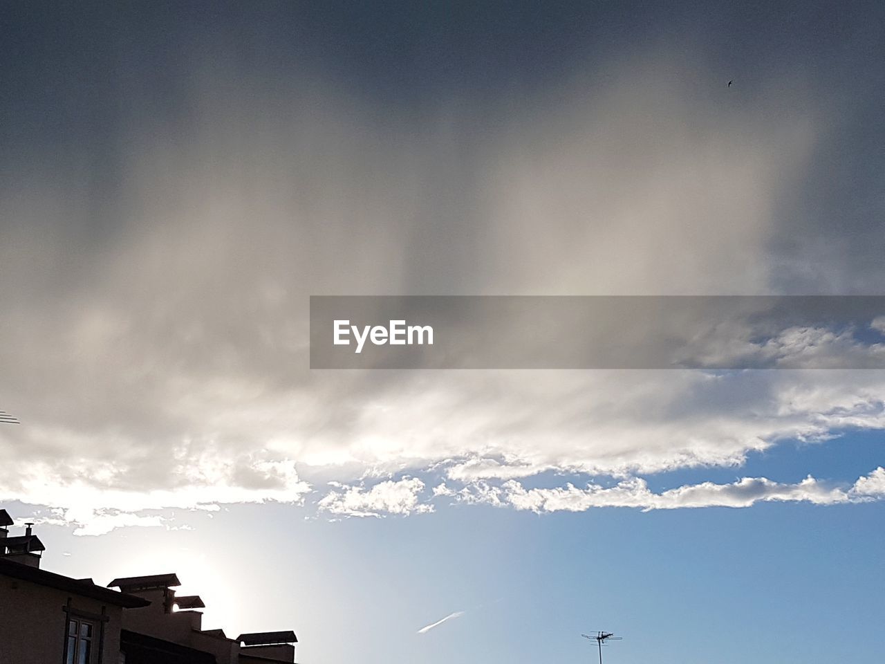 LOW ANGLE VIEW OF SILHOUETTE VAPOR TRAIL IN SKY