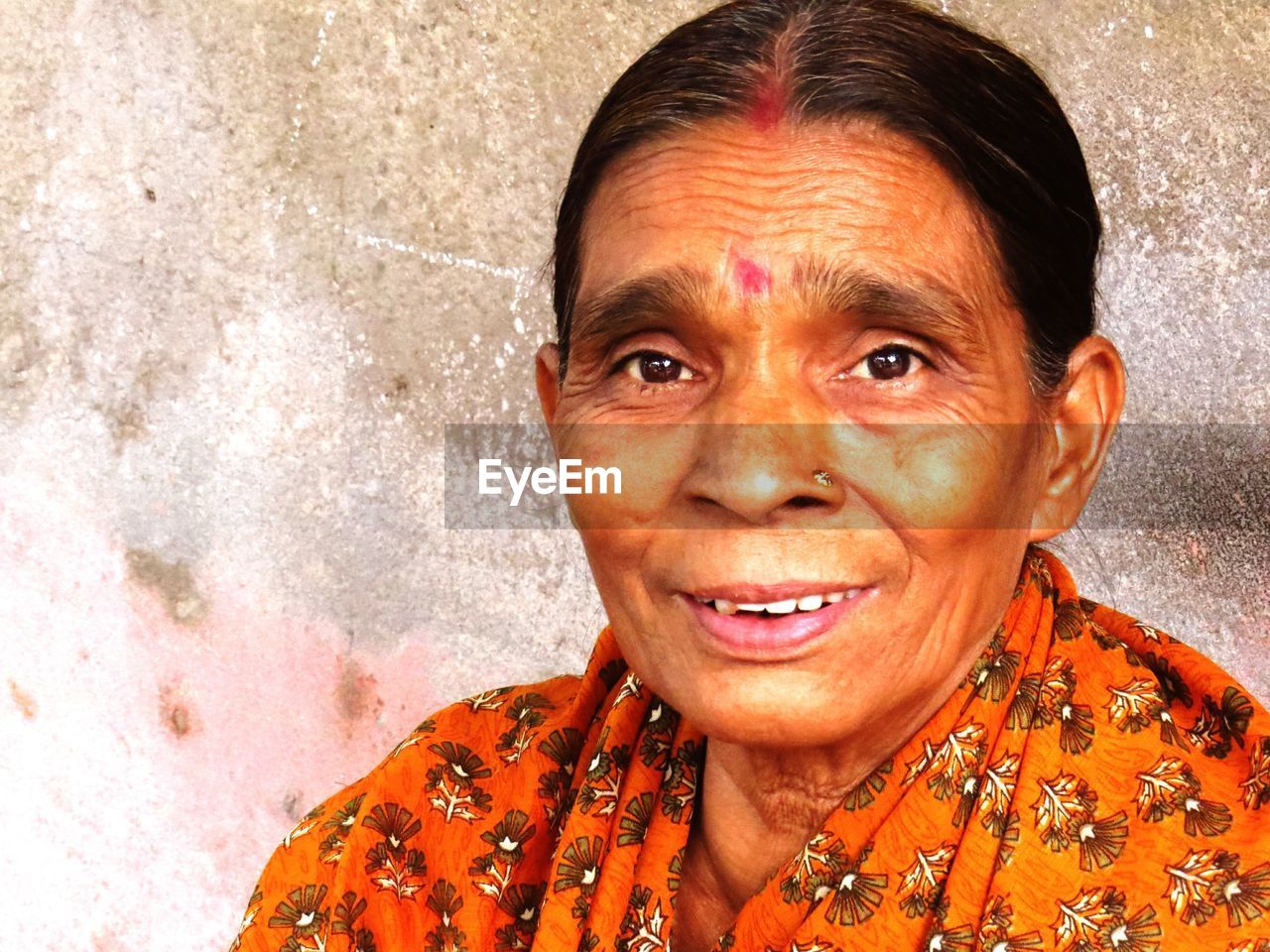 Portrait of mature woman wearing sari against wall