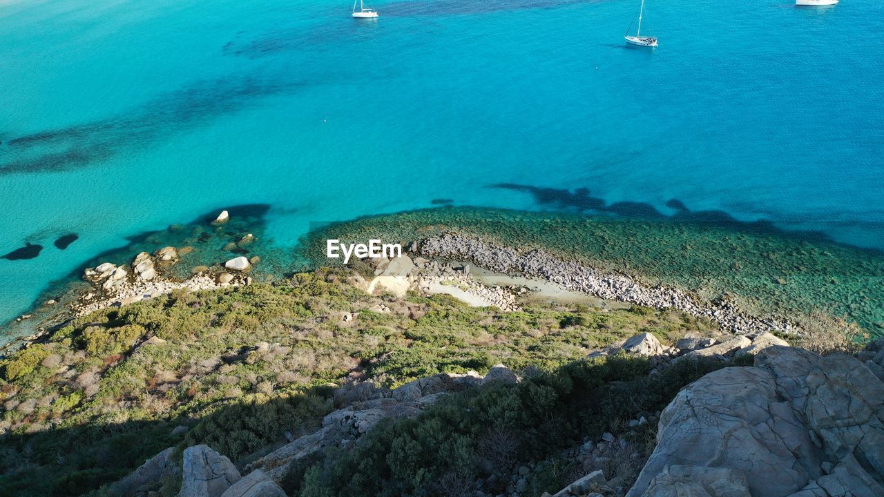 water, sea, land, coast, beach, nature, beauty in nature, high angle view, scenics - nature, nautical vessel, archipelago, islet, ocean, day, no people, aerial photography, transportation, aerial view, travel, island, reef, travel destinations, blue, rock, terrain, tranquility, turquoise colored, coastline, outdoors, tranquil scene, bay, shore, mode of transportation, idyllic, tourism, environment, underwater