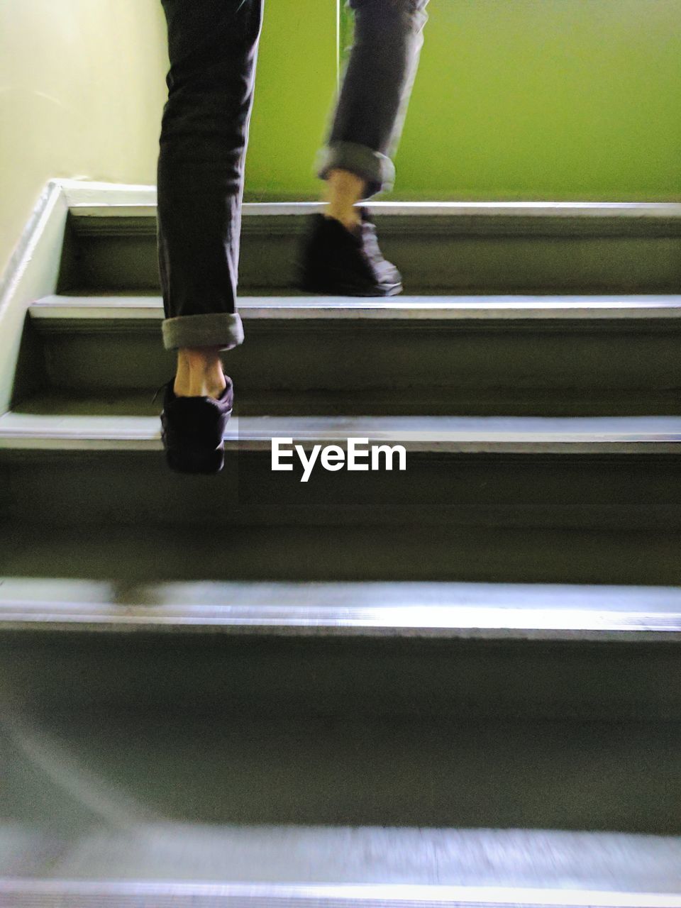 Low section of person moving up stairs