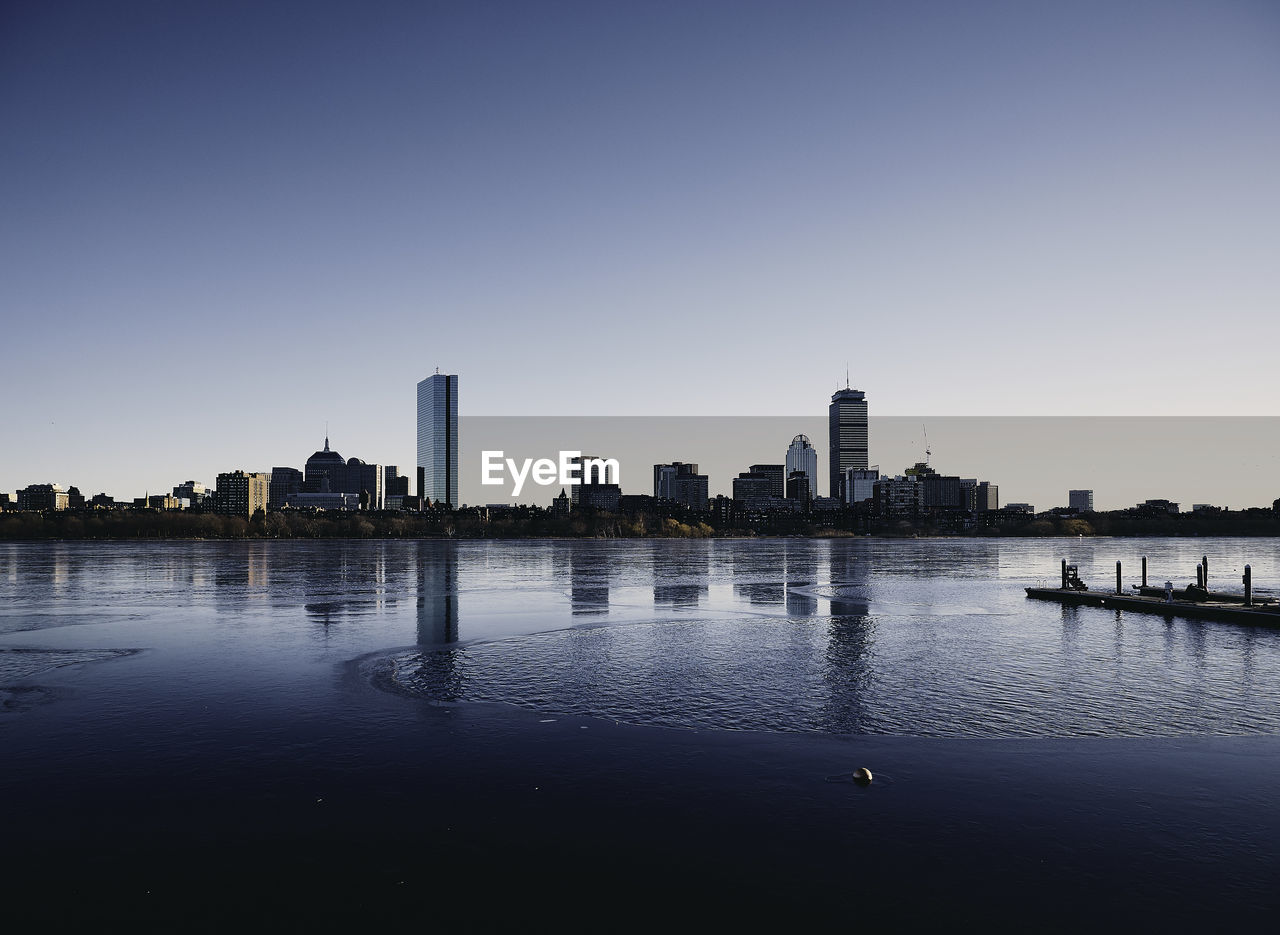 City skyline against clear sky during sunset