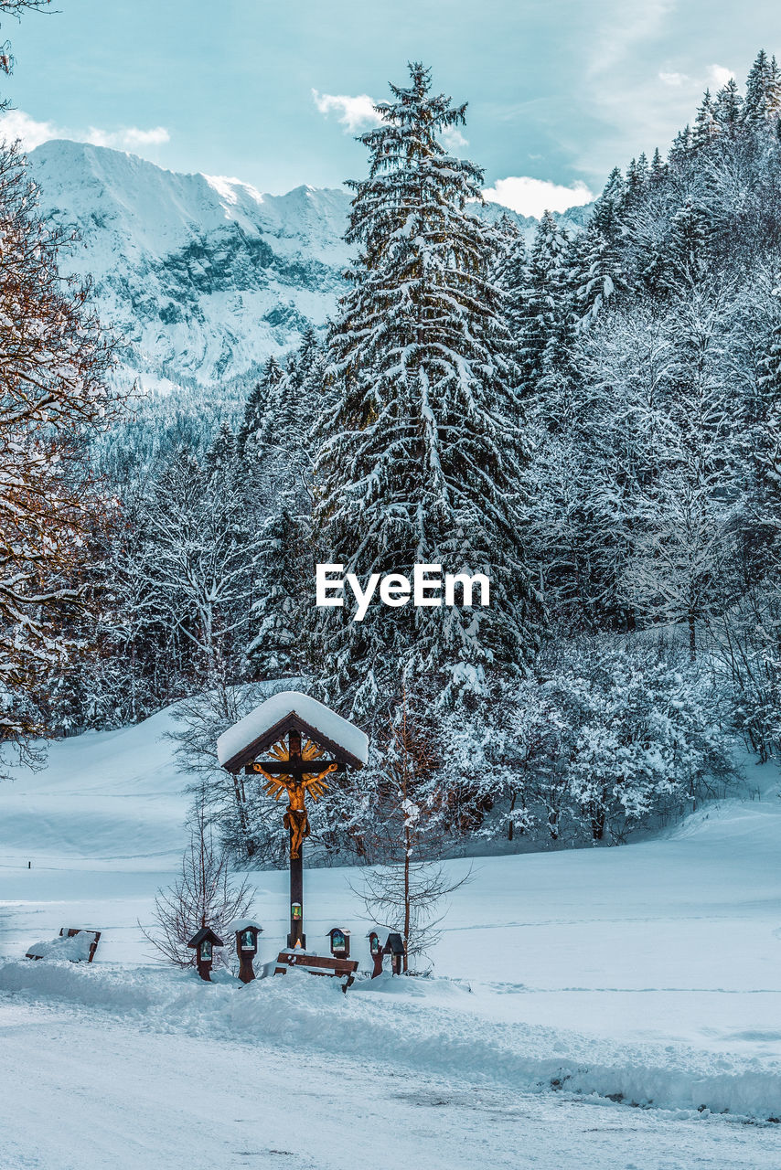 Scenic view of snow covered field against sky