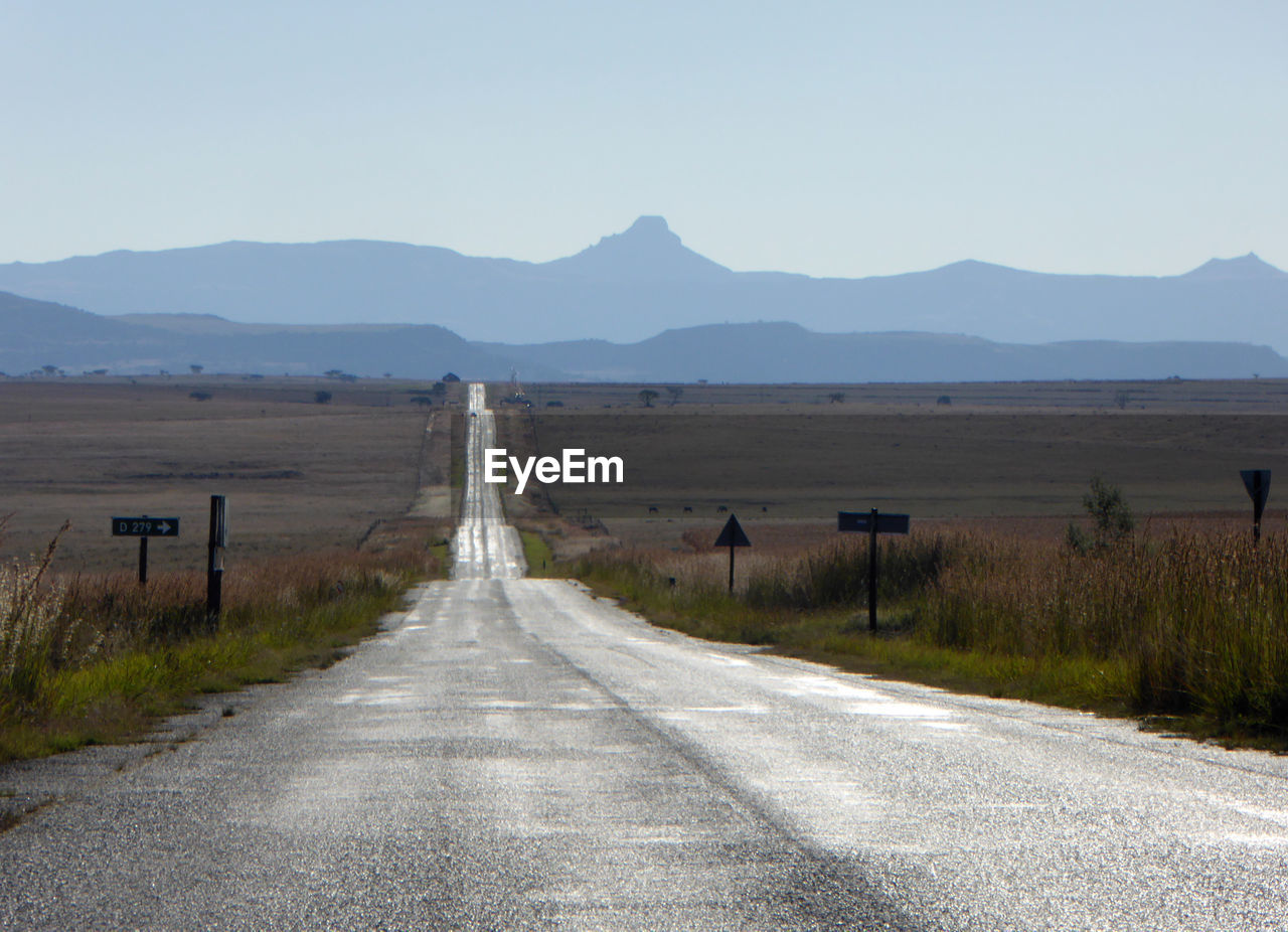 Empty road along countryside landscape