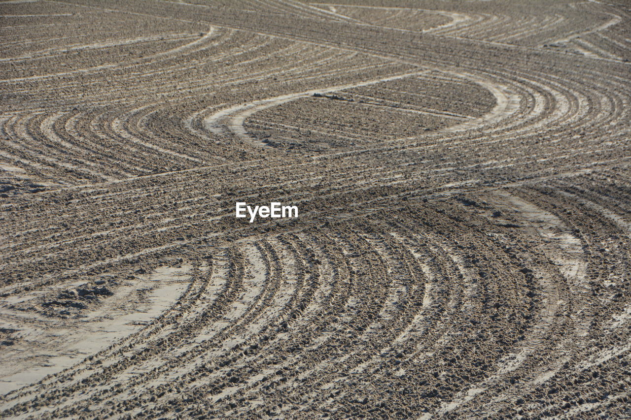 High angle view of tire tracks on land