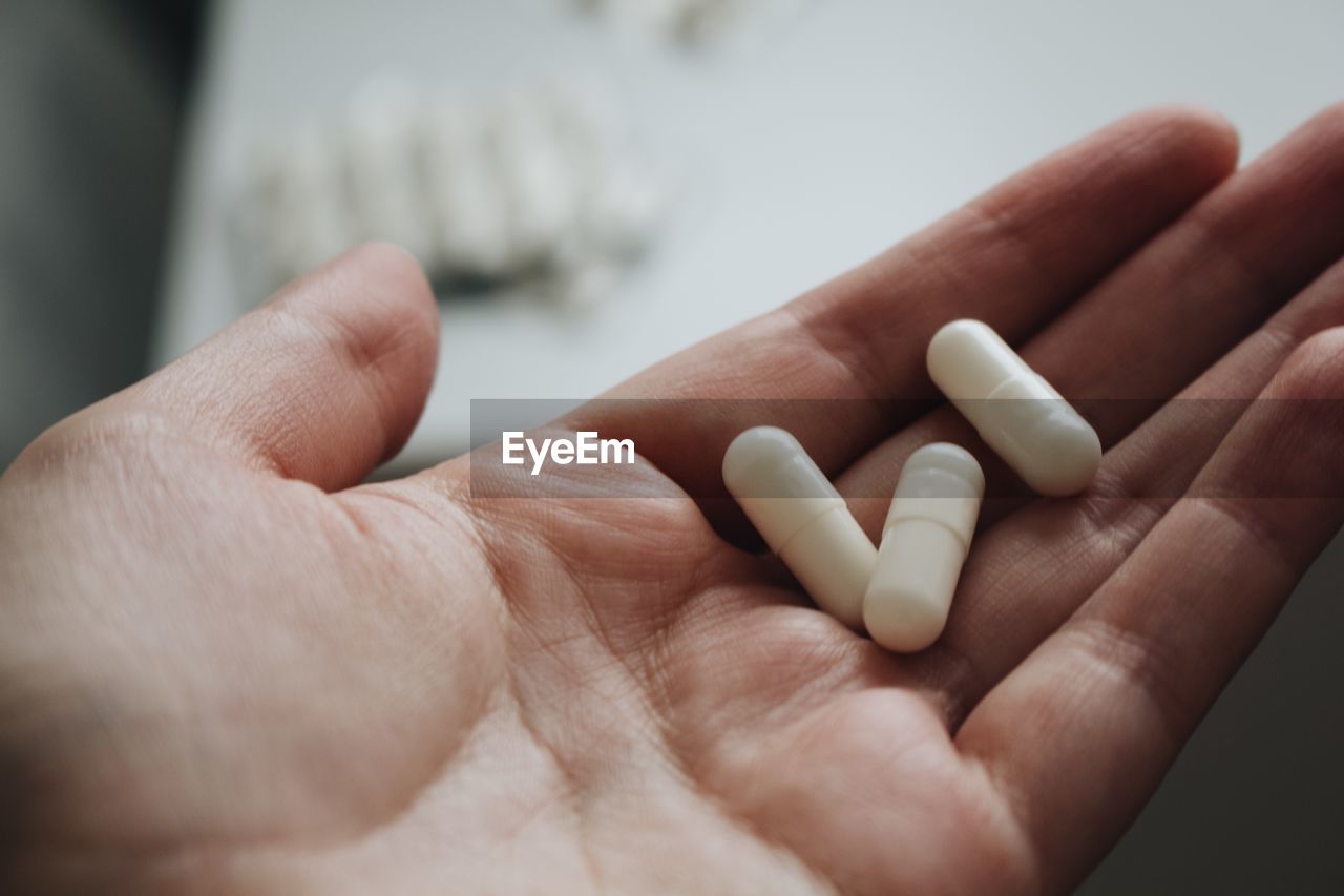 Close-up of human hand holding pills