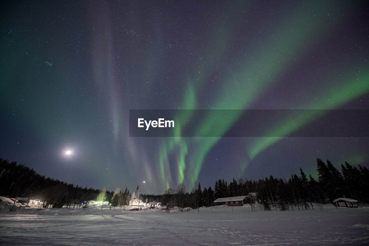 Scenic view of snow covered landscape against sky at night