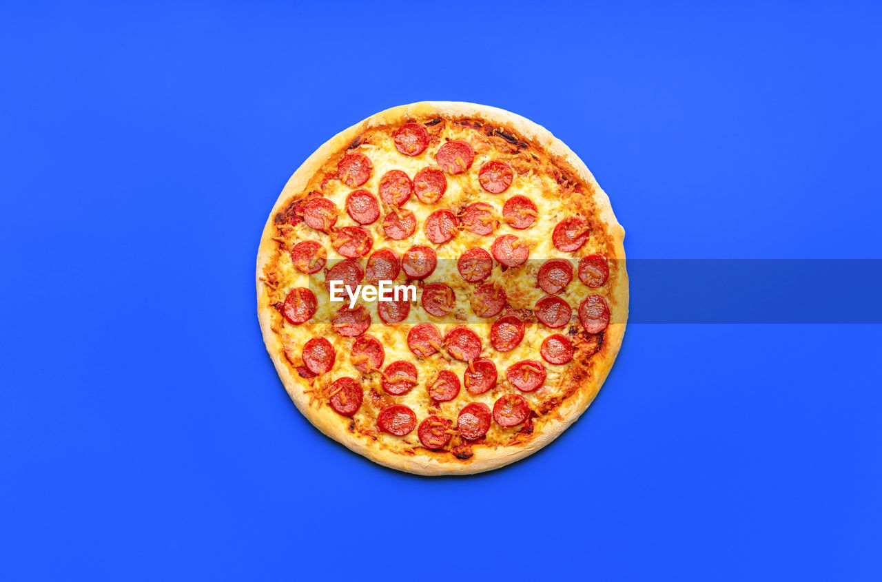 directly above shot of pizza against blue background