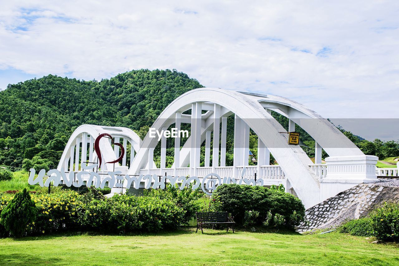 ARCH BRIDGE OVER PLANTS AGAINST SKY