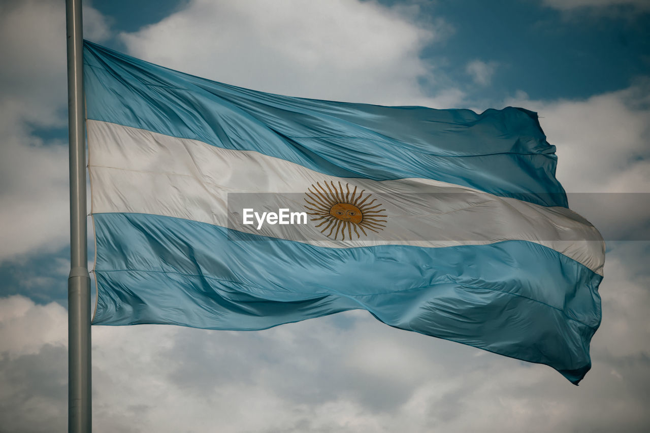 Low angle view of argentinian flag waving against sky