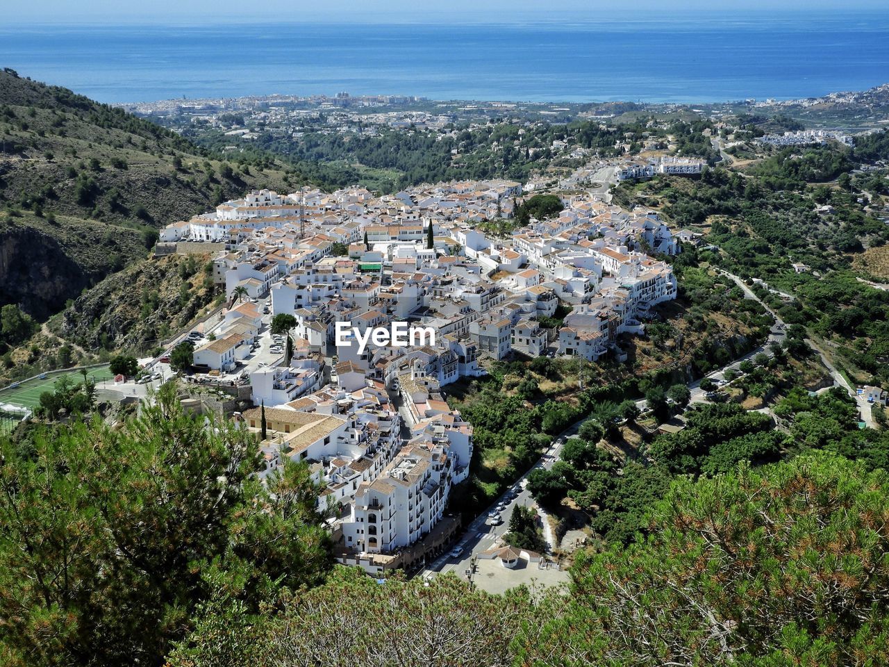 High angle view of buildings and trees in city