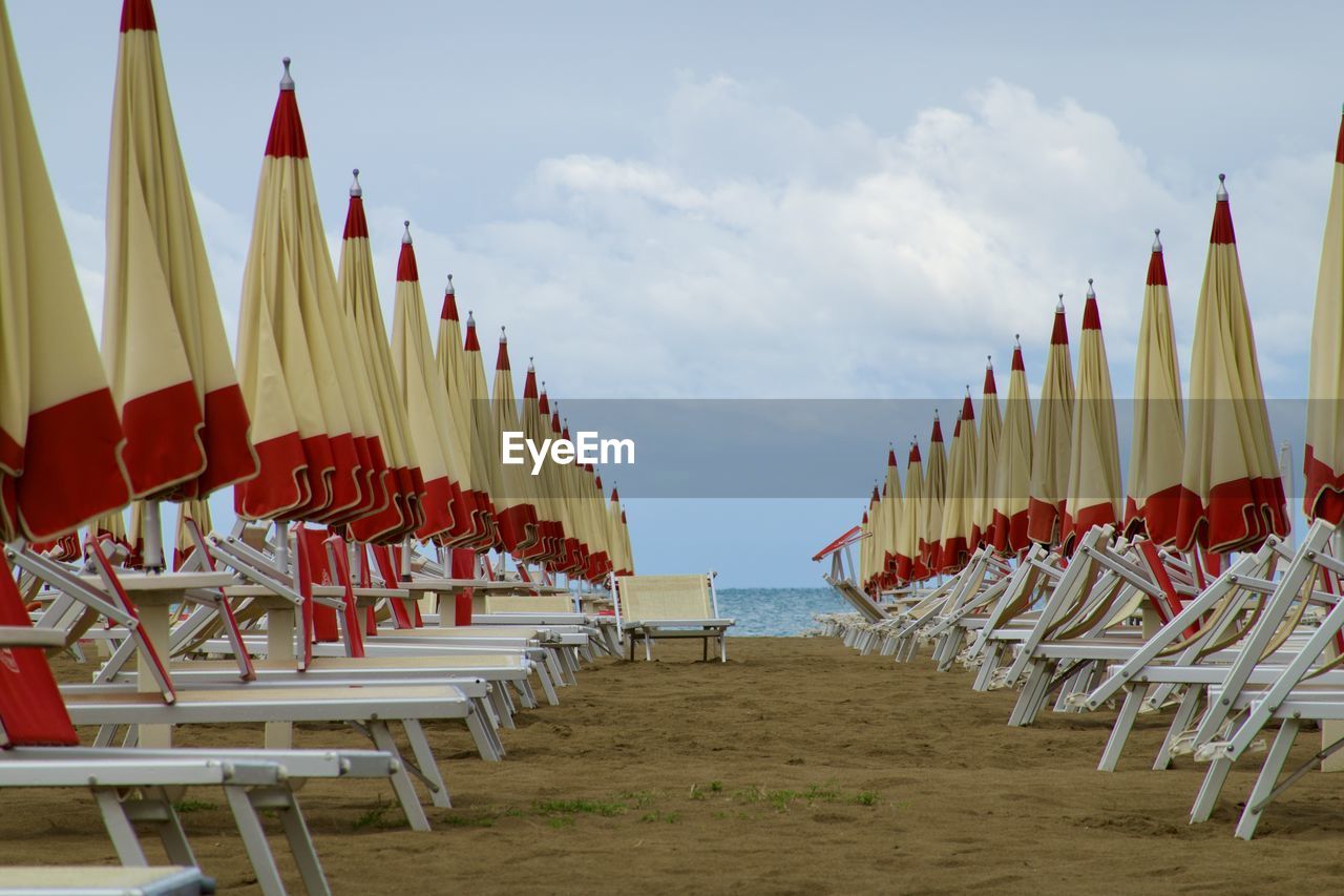 Scenic view of beach umbrellas against sky
