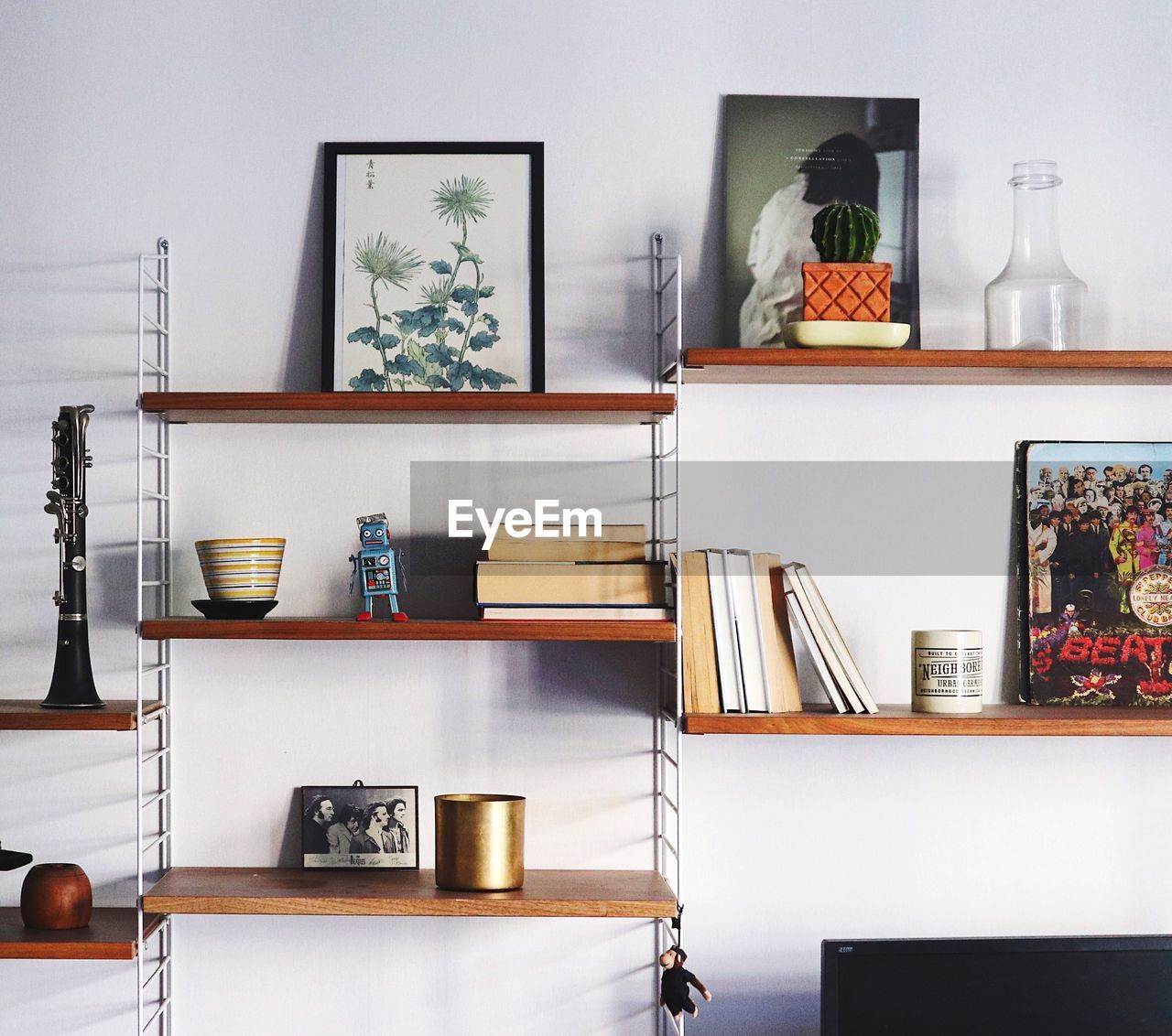 Close-up of various objects on shelf against wall