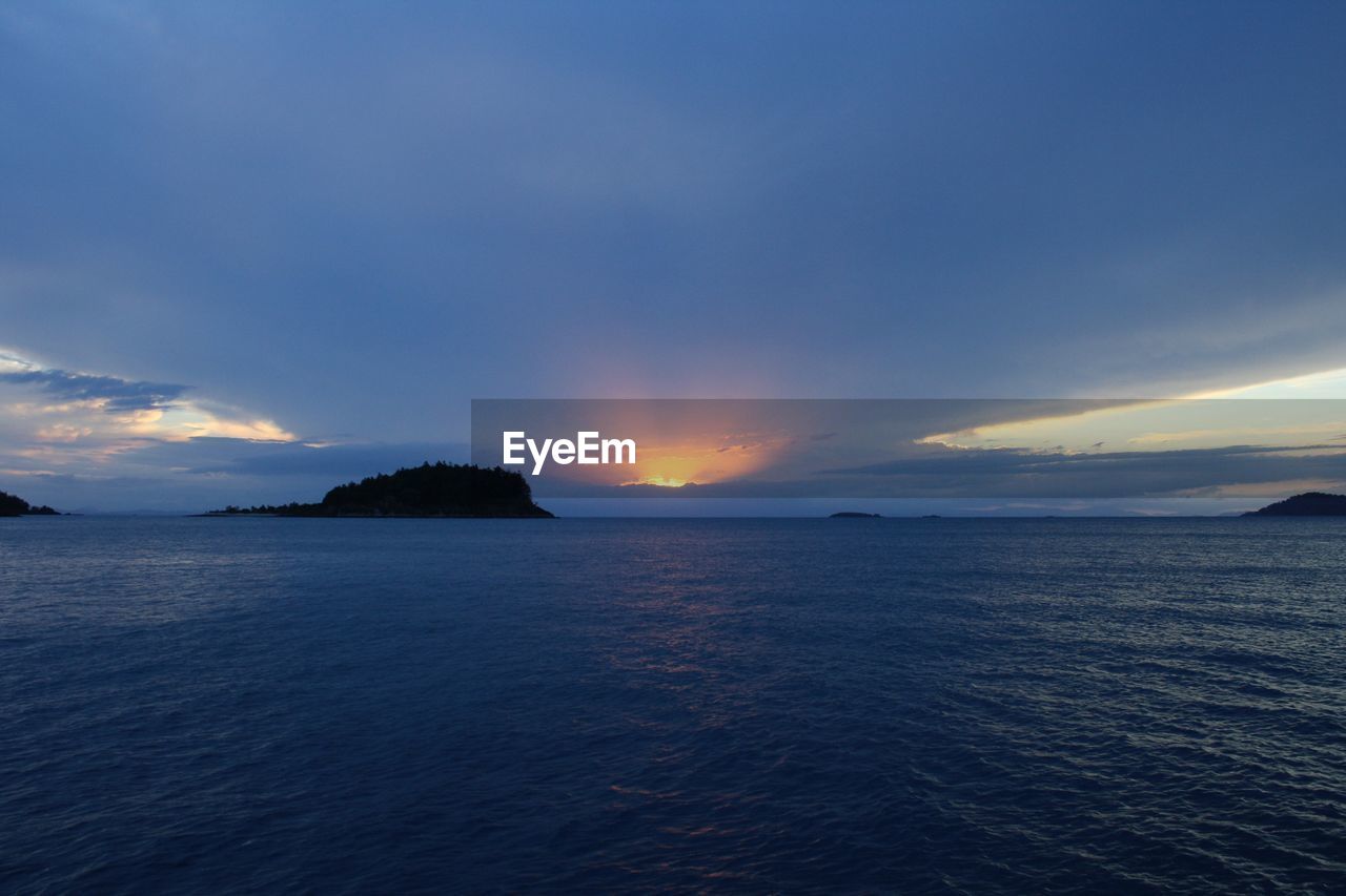 Scenic view of sea against cloudy sky