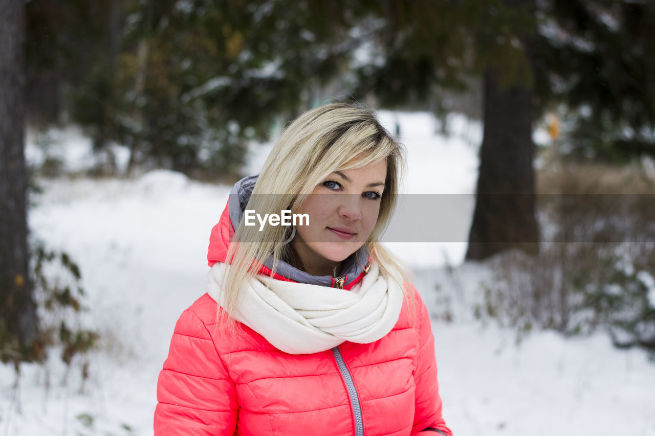 Portrait of woman standing in snow