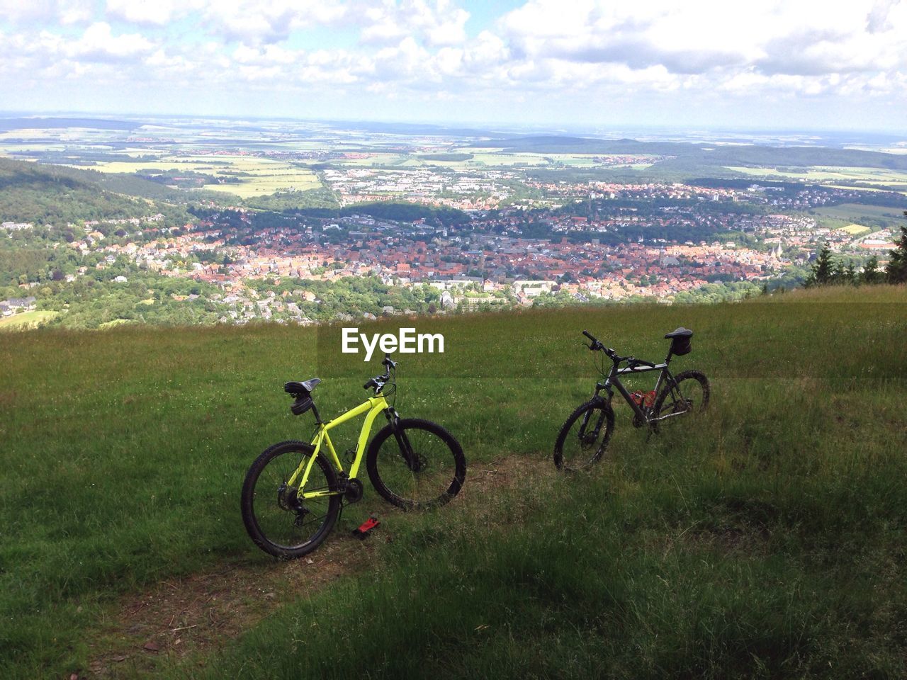 Bicycle on grassy landscape with town in background