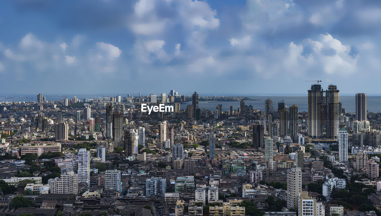 Aerial view of modern buildings in city against sky