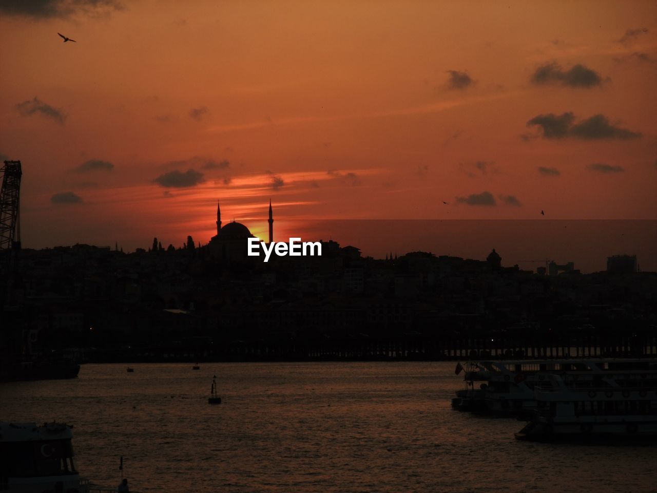 SILHOUETTE OF BUILDINGS AT WATERFRONT